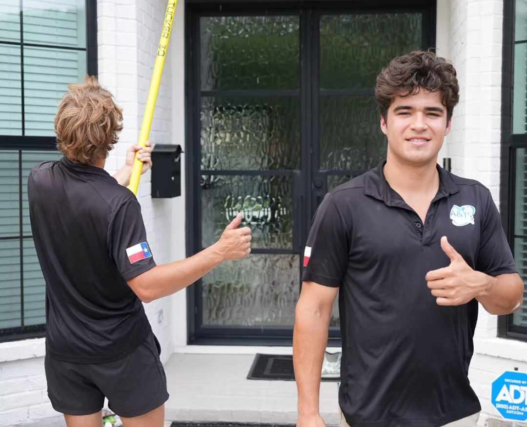 A&T's Pressure Washing crew cleaning a Houston home exterior
